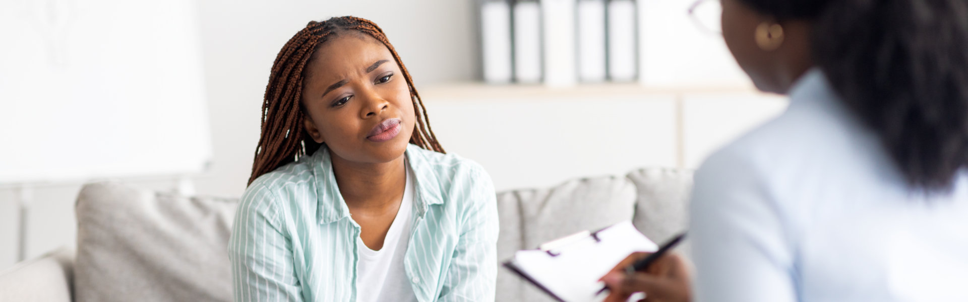 woman having counseling session with therapist at modern clinic